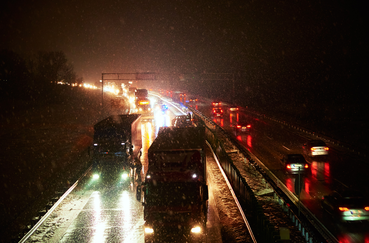 Car accident on slippery road at night during snowfall, Dangerous driving during winter snowstorm