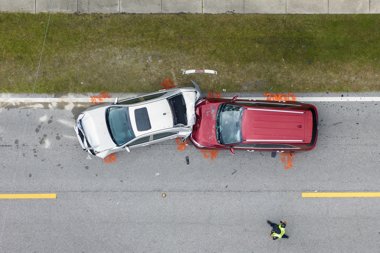 Car crash with two vehicles collided at traffic accident site on American street.