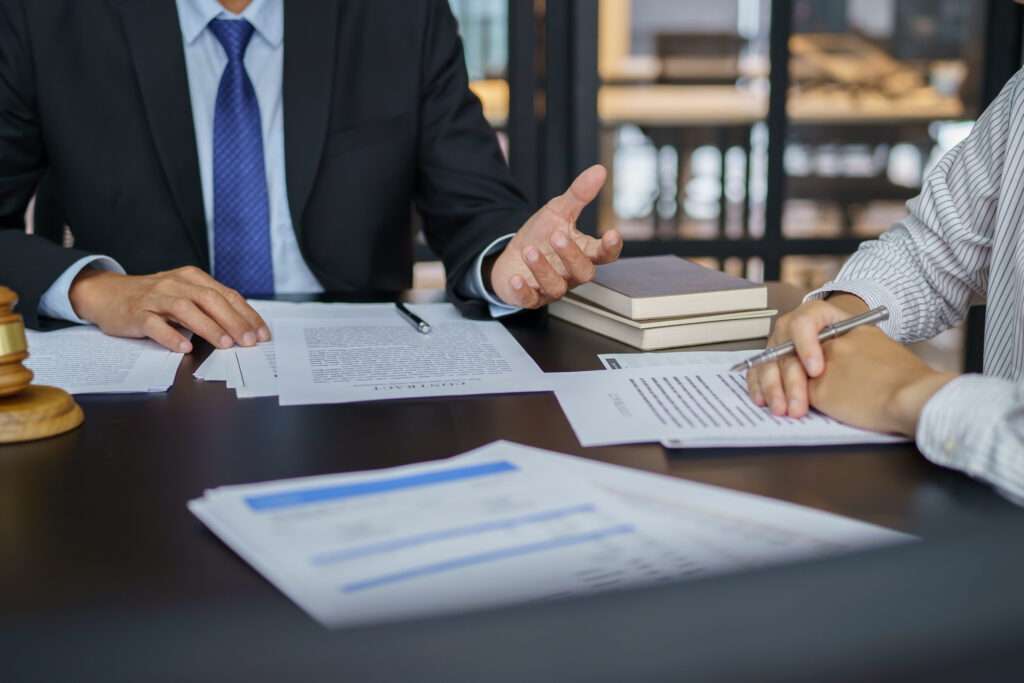 Two professionals sitting at a table looking over documents
