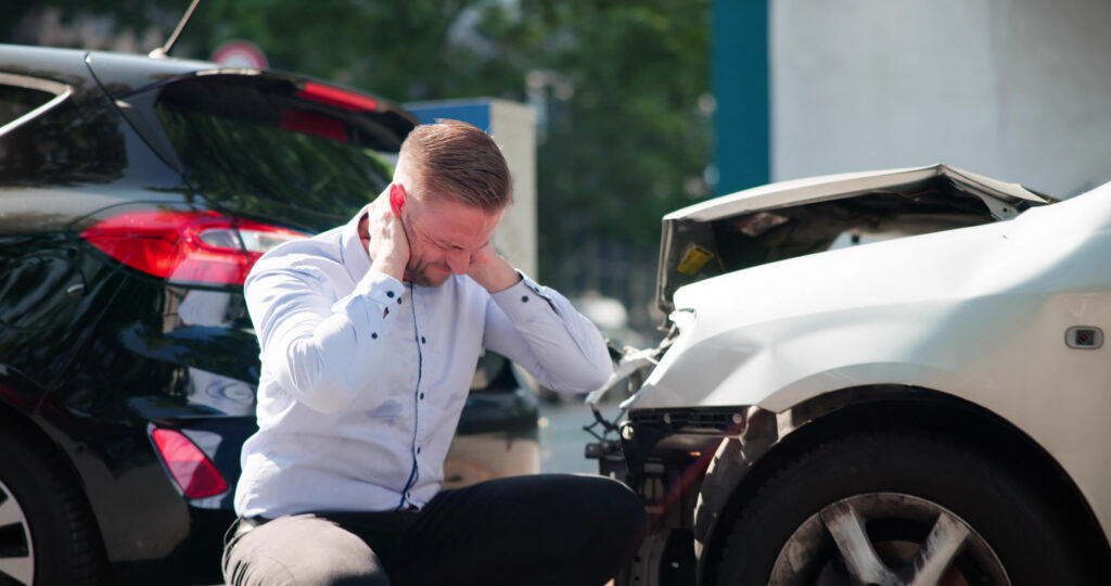 Young Male Driver Seeks Legal Aid After Car Injury Whiplash.